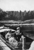Original title:  Dr. and Mrs. Alexander Graham Bell in their motorboat Ranzo at Beinn Bhreagh. 