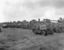Titre original&nbsp;:  Tank crews of The British Columbia Dragoons lined up in front of their Sherman tanks during a review by General H.D.G. Crerar followed by a mounted marchpast, Eelde, Netherlands, 23 May 1945. 